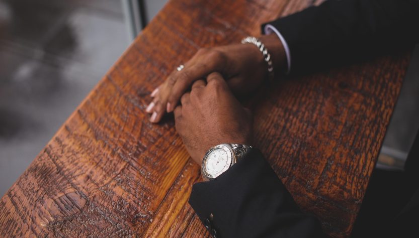 Business, hands, wristwatch — Florida Living Shield: Exploring Renters Insurance Options for Residents