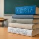 Stack of technical books with diagrams on the covers in a classroom setting