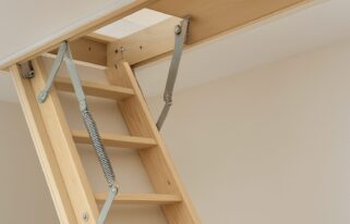 Close-up of a loft ladder mechanism showing steps and springs